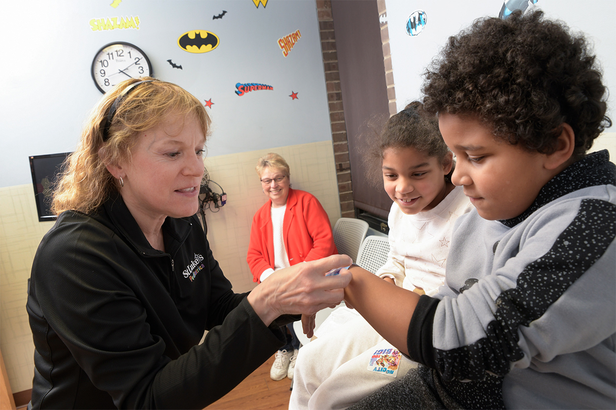 Medical professional assisting children at an appointment